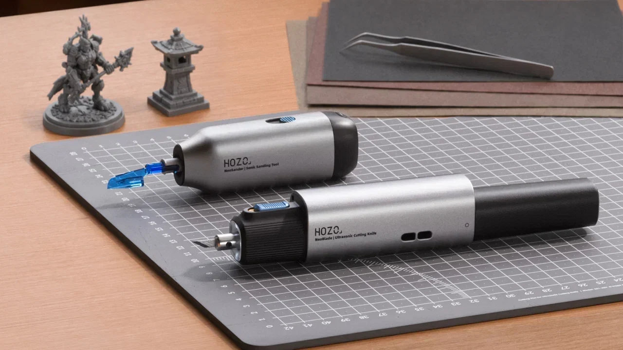 HOZO sanding tool and cutting knife on cutting mat with miniatures.