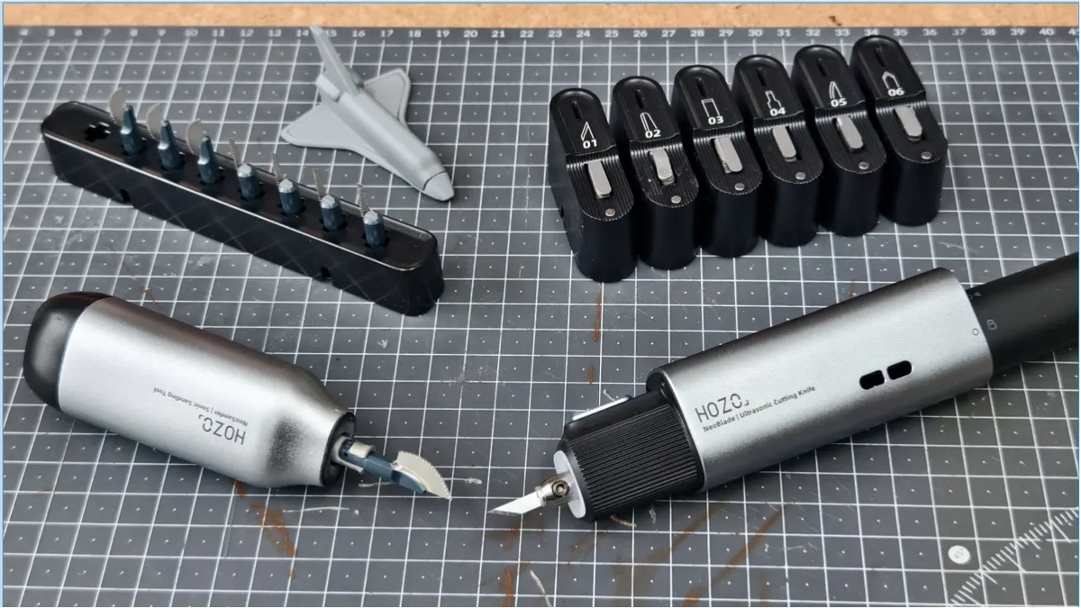 HOZO NeoBlade vs NeoSander Saw Blade comparison: ultrasonic cutter and precision saw blade accessories arranged on a cutting mat.